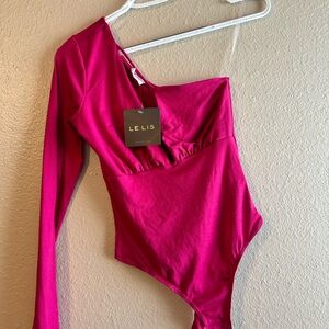 Hot pink one shoulder shirt.